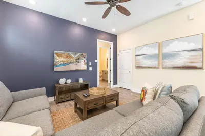 a living room with a couch and a ceiling fan at Blue Cottage Near Disney With Margaritaville Resort & Island H2O Access - 8067Kd in Orlando