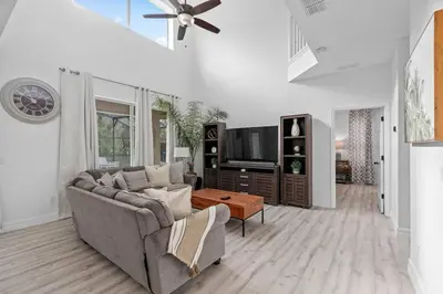 a living room with a couch and a tv at Tropical 7BR Heated Pool Pet Friendly Disney in Kissimmee