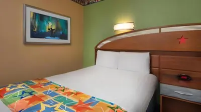 a bedroom with a bed and a picture on the wall at Disney's All-Star Music Resort in Orlando