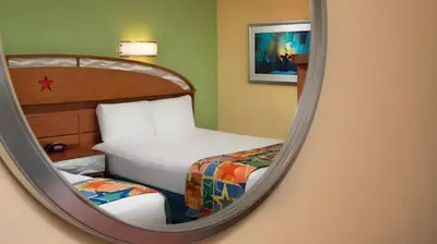a mirror reflection of a bedroom with two beds at Disney's All-Star Music Resort in Orlando