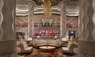 a lobby of a hotel with a couch and chairs at Disney's Coronado Springs Resort in Orlando