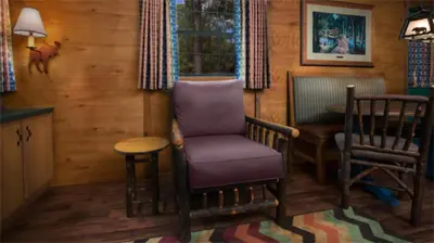 a living room with a chair and a table at The Cabins at Disney's Fort Wilderness Resort in Orlando
