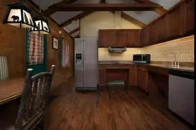 a kitchen with a refrigerator and a counter top at The Cabins at Disney's Fort Wilderness Resort in Orlando