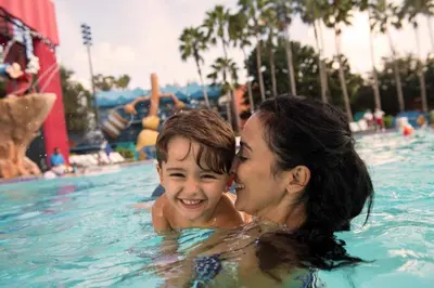 a woman and a child in a swimming pool at Disney's All-Star Movies Resort in Orlando