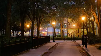 a street at night with street lights and a building at Disney's Port Orleans Resort - French Quarter in Orlando