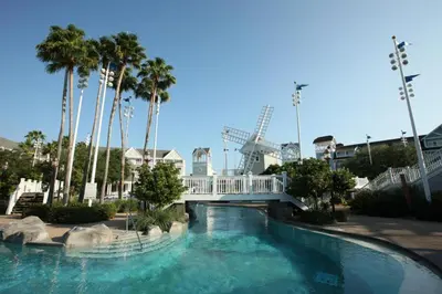 a swimming pool with a bridge and a amusement park at Disney's Beach Club Resort in Orlando