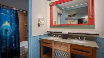 a bathroom with two sinks and a mirror at Disney's Port Orleans Resort - Riverside in Orlando