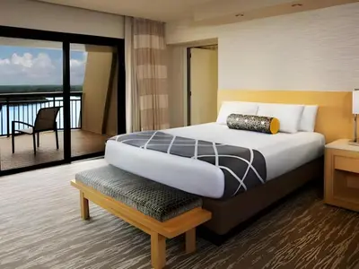 a bedroom with a large bed and a balcony at Disney's Contemporary Resort in Orlando