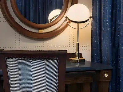 a table with a lamp and a mirror at Disney's Yacht Club Resort in Orlando