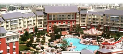 a resort with a large swimming pool and buildings at Disney's Boardwalk Inn in Orlando
