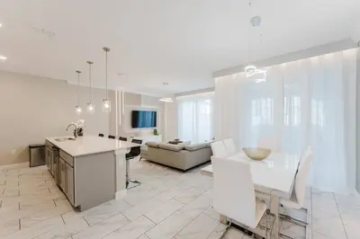 a kitchen and living room with a table and a couch at 3017 SL new 11 guests heat pool BBQ near Disney in Kissimmee