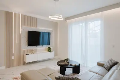 a living room with a couch and a tv on a wall at 3017 SL new 11 guests heat pool BBQ near Disney in Kissimmee
