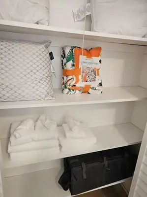 a closet filled with white towels on shelves at Foodie Lovers Walkable Mills50 - Sleeps 10 - Near Airport in Orlando