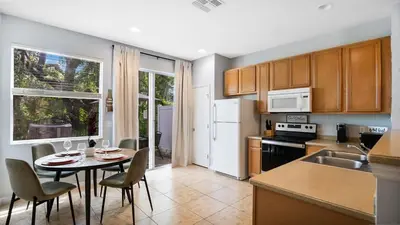 a kitchen with a table and chairs in a kitchen at Family Friendly Townhome Near Attractions in Orlando