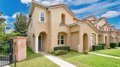 a large house with a fence in front of it at Quiet Corner Gem in Gated Crestwynd Bay in Orlando