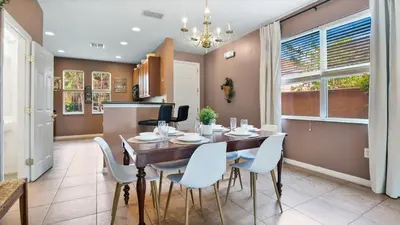 a kitchen and dining room with a table and chairs at Quiet Corner Gem in Gated Crestwynd Bay in Orlando