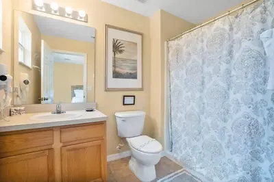 a bathroom with a toilet and a sink and a shower at Relaxing Getaway in Emerald Island Near Disney in Kissimmee