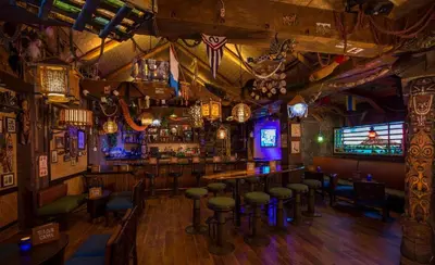 a bar with a bunch of stools in a room at Disney's Polynesian Village Resort in Orlando
