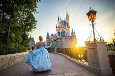 a woman in a blue dress in front of a castle at Disney's Polynesian Village Resort in Orlando