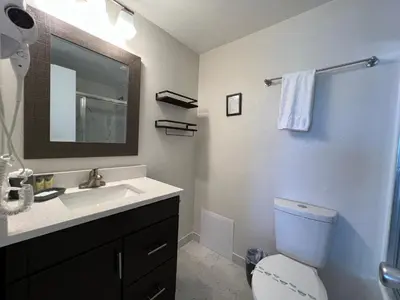 a bathroom with a sink and a toilet and a mirror at 15 - Amazing Vulcano Bay - Universal View in Orlando