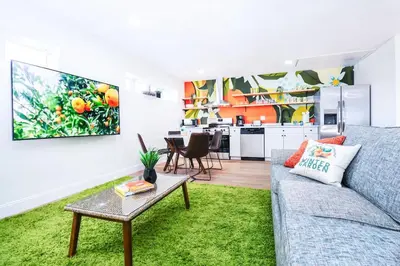 a living room with a couch and a table at StylishAptWtrGrdnOppLake&Prk&Yrd in Orlando