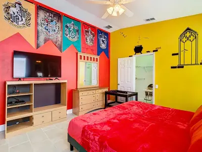 a colorful bedroom with a bed and a tv at T8134-Windsor Palms Resort Pool and Spa Near Disney in Kissimmee