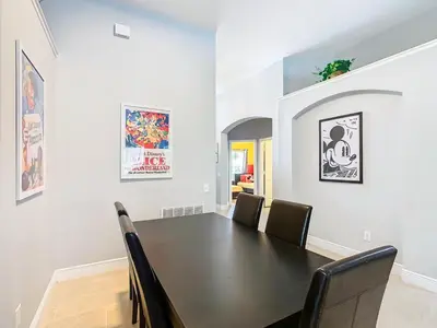 a dining room with a black table and chairs at T8134-Windsor Palms Resort Pool and Spa Near Disney in Kissimmee