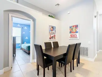 a dining room with a table and chairs and a bedroom at T8134-Windsor Palms Resort Pool and Spa Near Disney in Kissimmee