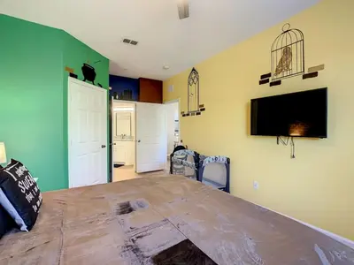a room with a large wooden table with a tv on the wall at C2785-203-Windsor Hills Resort Free Water Park Themed Rooms in Orlando