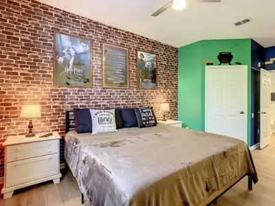 a bedroom with a brick wall and a large bed at C2785-203-Windsor Hills Resort Free Water Park Themed Rooms in Orlando