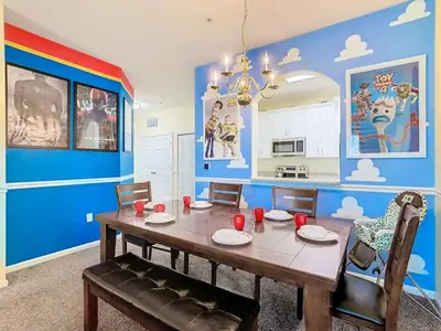 a dining room with a table and a blue wall at C2821-403-Windsor Hills Resort-Free Water Park-2 Miles to Disney in Orlando