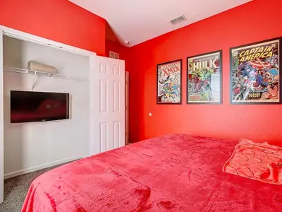 a red bedroom with a bed and a tv at C2821-403-Windsor Hills Resort-Free Water Park-2 Miles to Disney in Orlando