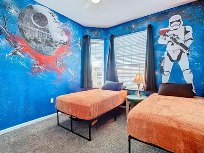 a bedroom with two beds and a mural of an astronaut at C2821-403-Windsor Hills Resort-Free Water Park-2 Miles to Disney in Orlando