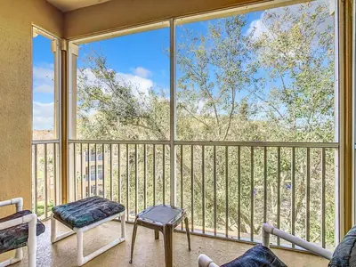 a living room with a large window with a view at C2821-403-Windsor Hills Resort-Free Water Park-2 Miles to Disney in Orlando