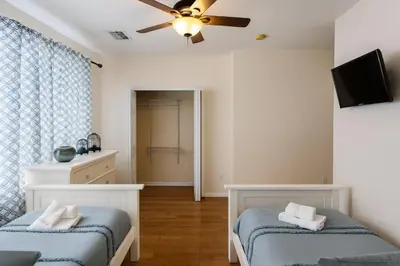 a bedroom with two beds and a ceiling fan at 3Q/3.5B Vista Cay Resort - 5 Minutos da Universal in Orlando