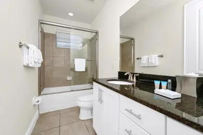 a white bathroom with a sink and a toilet at Regal Home With Private Pool Near Disney With Waterpark & Resort Access At Encore Resort - 7727Ff in Kissimmee