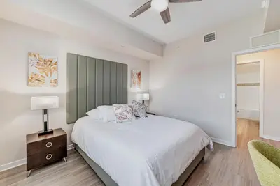 a white bedroom with a bed and a ceiling fan at Vista Cay by CY -Harry Potter 3BR in Orlando