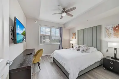 a bedroom with a bed and a ceiling fan at Vista Cay by CY -Harry Potter 3BR in Orlando