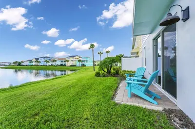 a couple of blue benches sitting on the side of a building at Magic Vacation Villa Near Disney With Margaritaville Resort & Island H20 Waterpark Access - 2932Or in Orlando