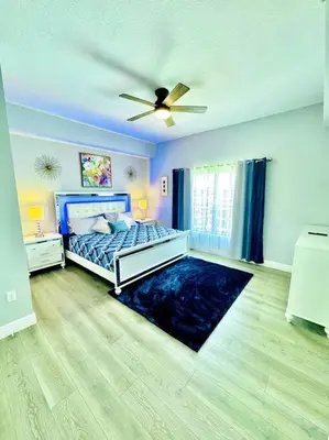 a bedroom with a bed and a ceiling fan at Luxurious & Epic Condo in heart of Orlando in Orlando