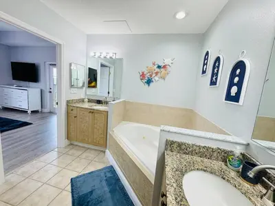 a large bathroom with a tub and a sink at Luxurious & Epic Condo in heart of Orlando in Orlando
