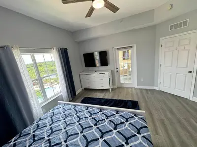 a bedroom with a bed and a ceiling fan at Luxurious & Epic Condo in heart of Orlando in Orlando