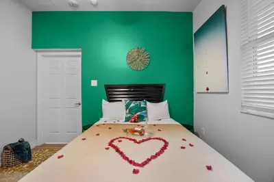a bedroom with a bed with a heart made out of roses at Banana Leaf Villa in Orlando