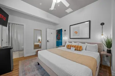 a bedroom with a large bed and a television at Banana Leaf Villa in Orlando