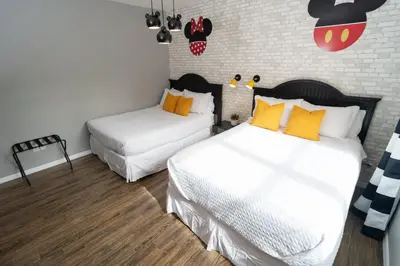 a bedroom with two beds with white and orange pillows at Magical Themed 3BR Townhouse Near the Parks in Kissimmee