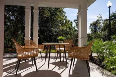 a patio with chairs and a table on a porch at Magical Themed 3BR Townhouse Near the Parks in Kissimmee