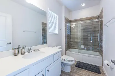 a bathroom with a sink and a toilet and a shower at Fantastic 5 BD Pool Near Disney Resort Perks in Kissimmee