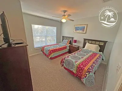 a bedroom with two beds and a flat screen tv at Standard four beds Villas Seven Dwrafs - Close to Disney in Kissimmee