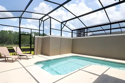 an indoor swimming pool with a glass ceiling at Villa Smile - 4Q/3B Storey Lake *Casa Luxuosa* in Kissimmee