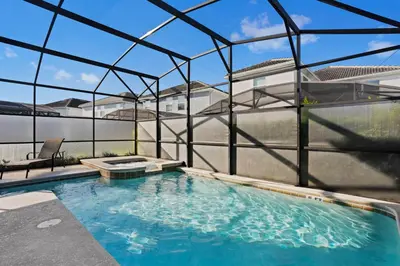 an indoor swimming pool with a glass house at 4718 Sleepy Hollow Drive in Kissimmee